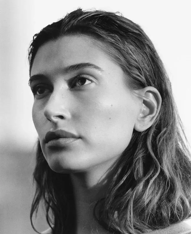 Black and white close-up portrait of woman with wet hair, minimal, photographic, monochrome
