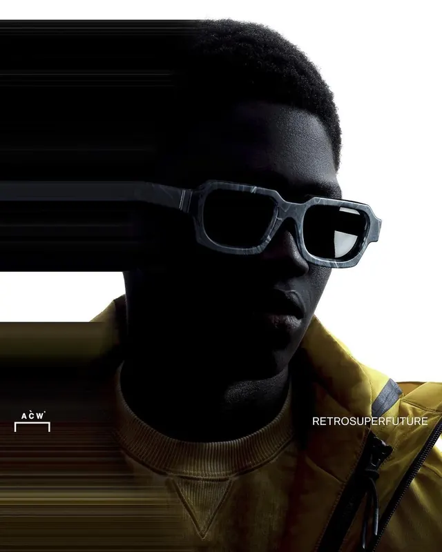 Close fashion portrait in yellow jacket and angular sunglasses, minimal, photographic, dark