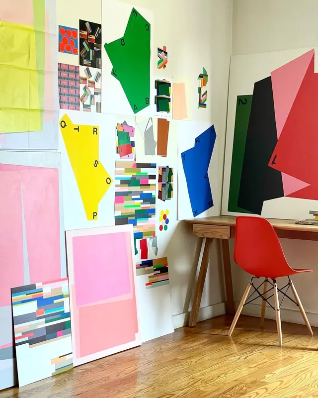 Geometric paper cutouts in artist studio, photographic, geometric, vibrant