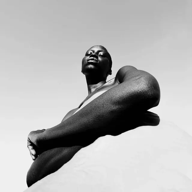 Dramatic low-angle black and white female portrait, photographic, monochrome, monochrome