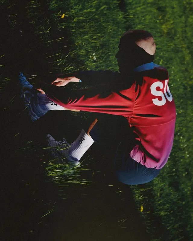 Person in Red Jacket on Grass
