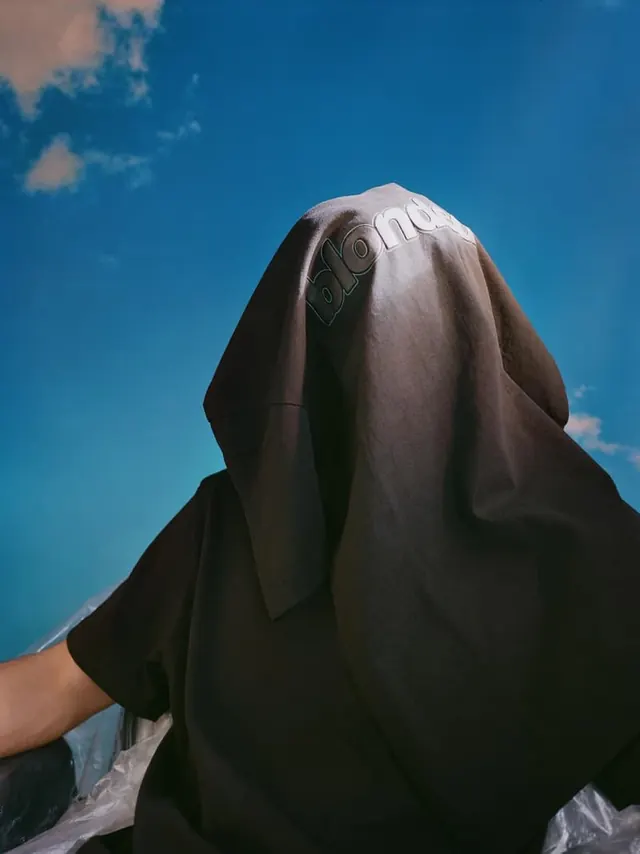 Figure in Veil against Blue Sky