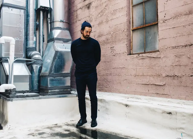 Portrait in urban industrial setting, photographic, editorial, dark