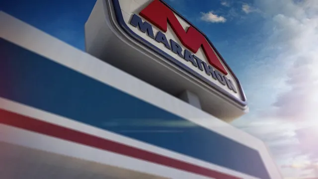 Marathon gas station sign against blue sky, photographic, corporate-clean, vibrant
