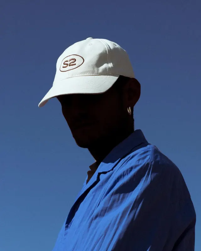 Man in White Cap and Blue Shirt