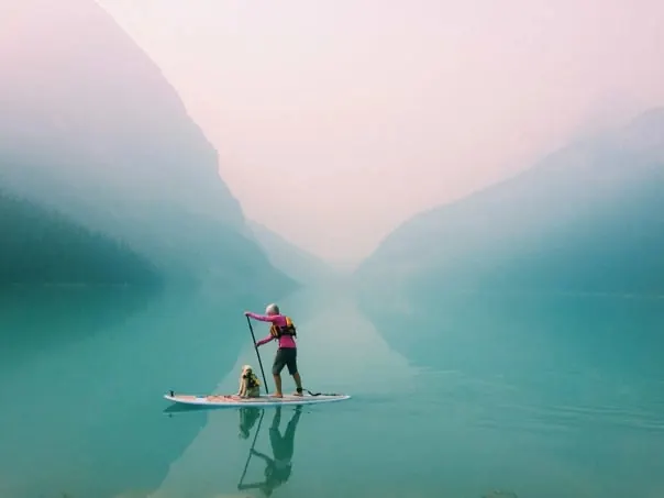Person on Paddleboard in Misty Lake