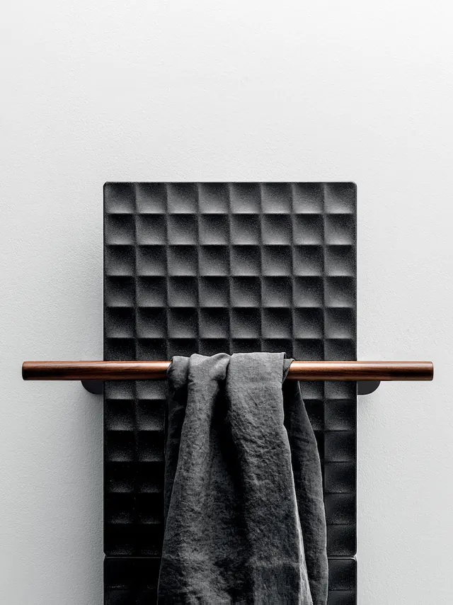 Waffle textured radiator with towel, minimal, photographic, monochrome