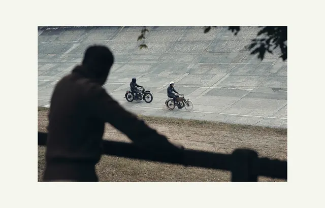 Vintage motorcycles on concrete track, photographic, editorial, muted