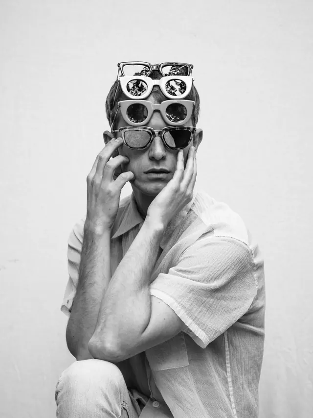 Stacked sunglasses portrait, photographic, minimal, monochrome