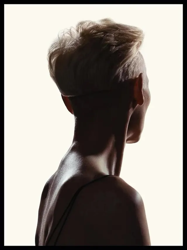 Rim-lit blonde haircut portrait, photographic, minimal, monochrome