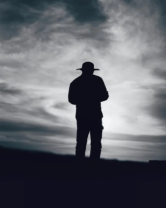 Silhouetted Figure in Cloudy Sky