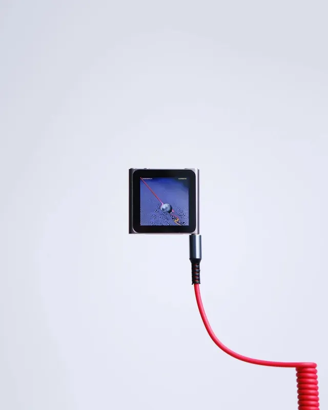 iPod Nano with red coiled cable, minimal, photographic, muted