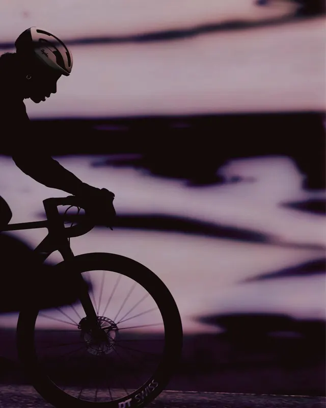 Purple-hour cyclist silhouette, minimal, photographic, cool