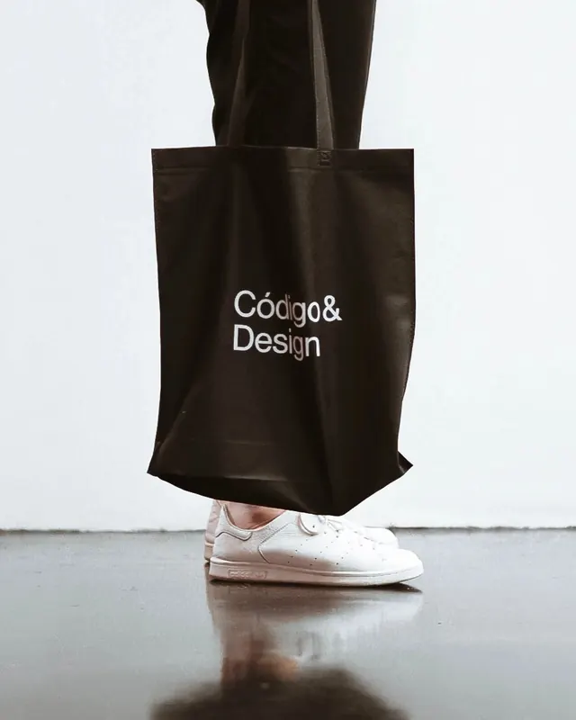 Codigo and Design tote lifestyle shot, minimal, corporate-clean, monochrome