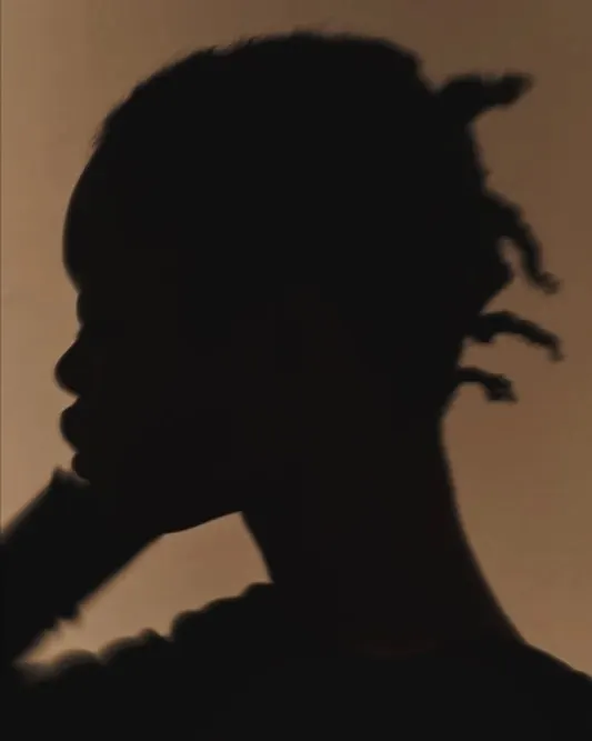 Profile silhouette on warm beige, minimal, photographic, warm