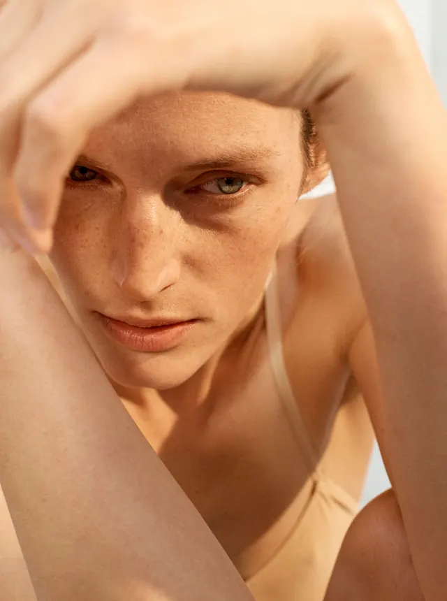 Freckled intimate close-up portrait, photographic, organic, warm