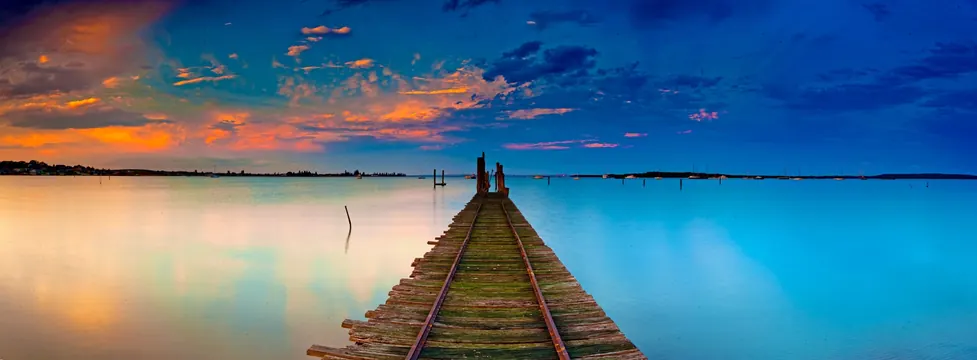 Railway pier sunset long exposure, photographic, minimal, vibrant