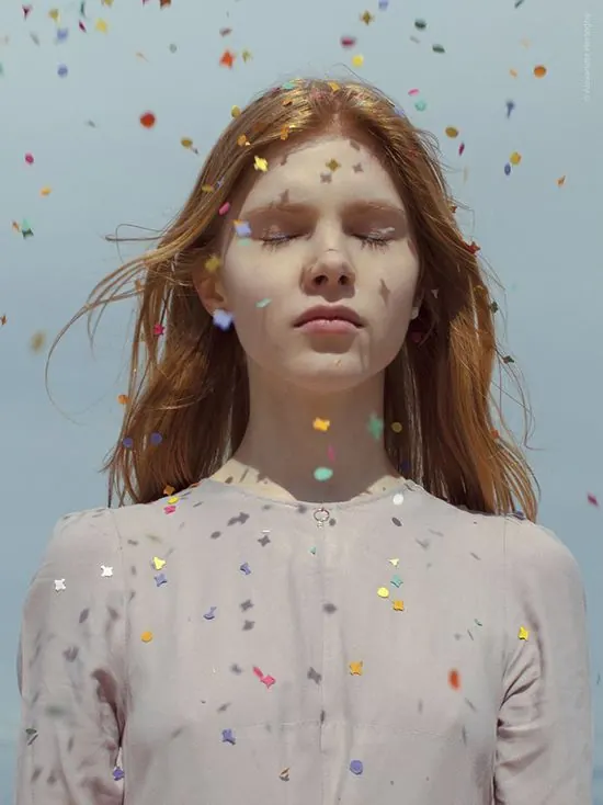 Confetti shadows on closed-eye portrait, photographic, editorial, light