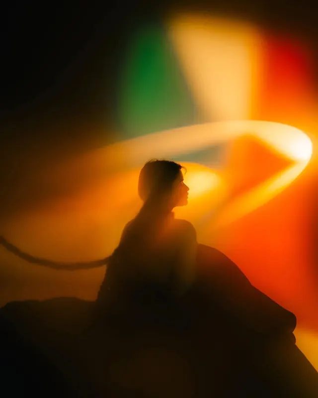 Silhouette in warm amber light leak, photographic, abstract, warm