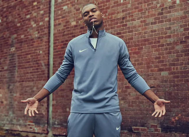 Nike tracksuit rosary editorial portrait, photographic, minimal, muted