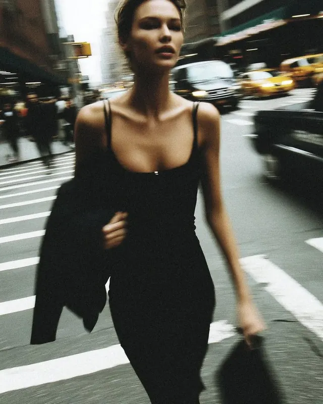 Motion-blur woman crossing NYC street, photographic, editorial, monochrome