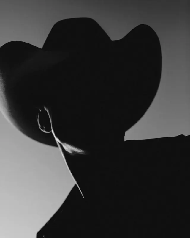 Cowboy hat silhouette portrait, photographic, minimal, monochrome