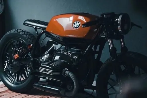 Burnt-orange BMW cafe racer, minimal, photographic, dark