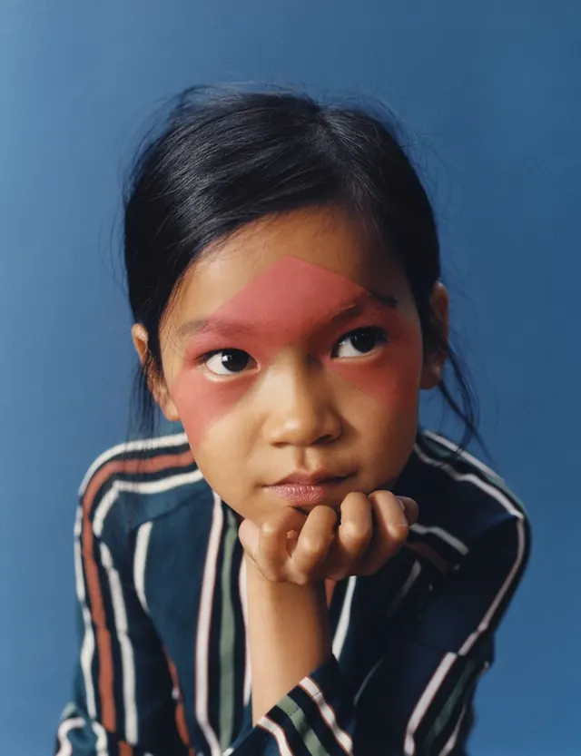 Child with house-shaped face paint, editorial, photographic, cool