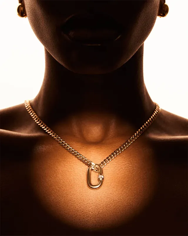 Gold chain necklace editorial close-up, luxury, photographic, warm