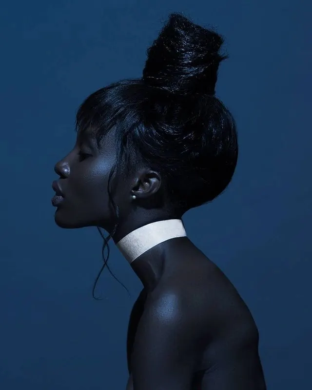 Blue-lit profile with white choker, editorial, photographic, cool