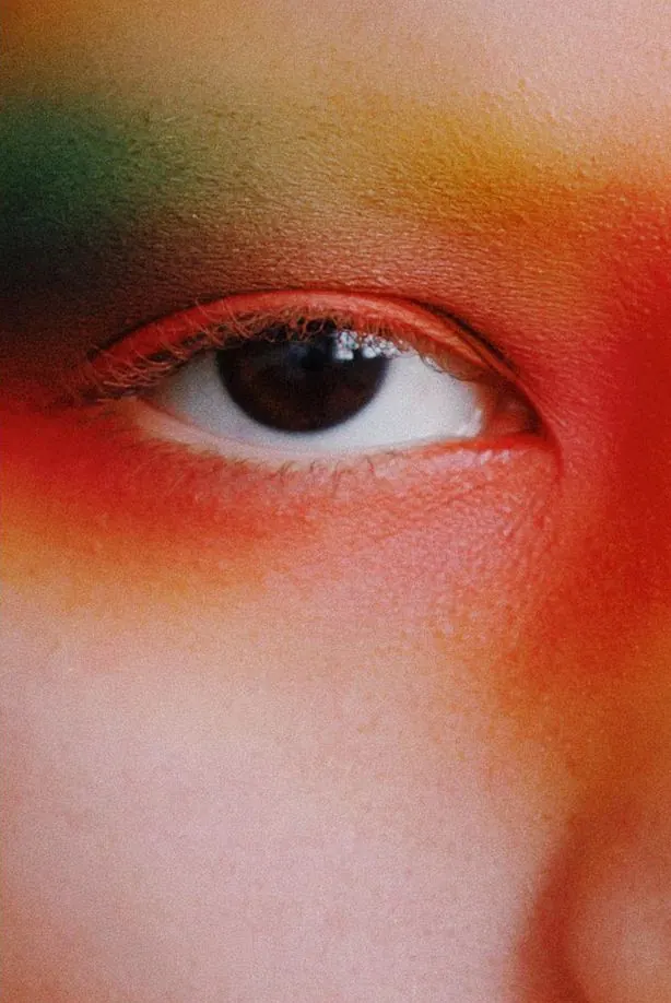 Macro eye with gradient face paint, editorial, photographic, vibrant