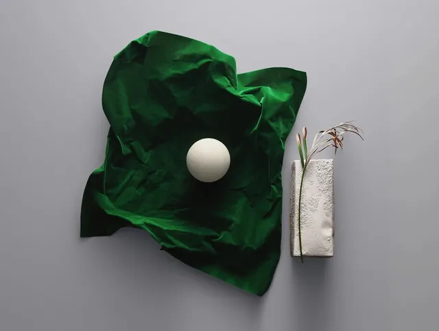 Green Fabric and Sphere Composition