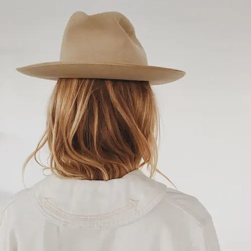 Woman in Tan Hat and White Jacket