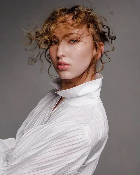 Portrait of a woman in a white textured shirt