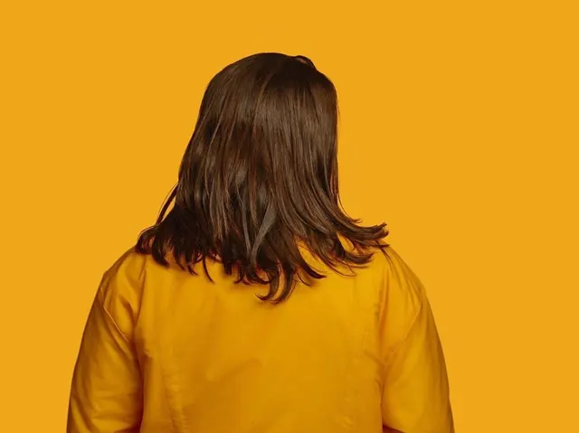 Person in Yellow Shirt against Yellow Background