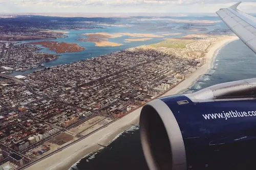 Aerial Cityscape and Aircraft Wing View