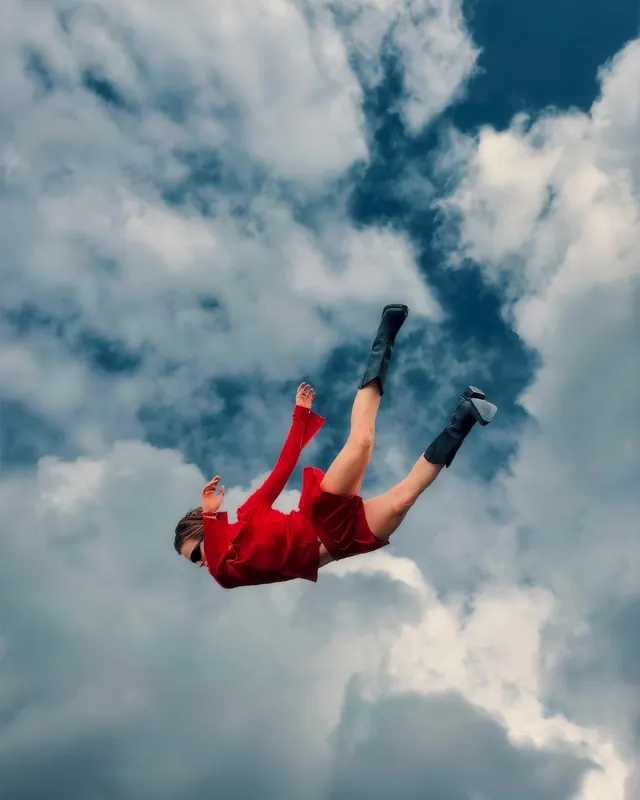 Person Jumping in Clouds