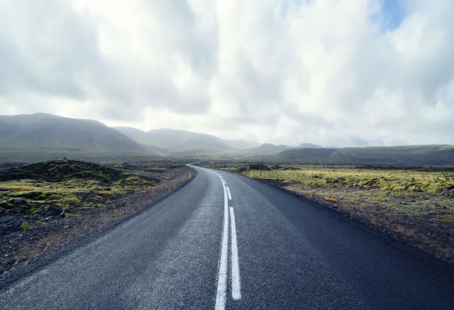 Empty road through Icelandic landscape, photographic, minimal, muted