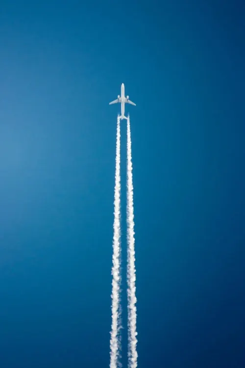 Airplane contrail against blue sky