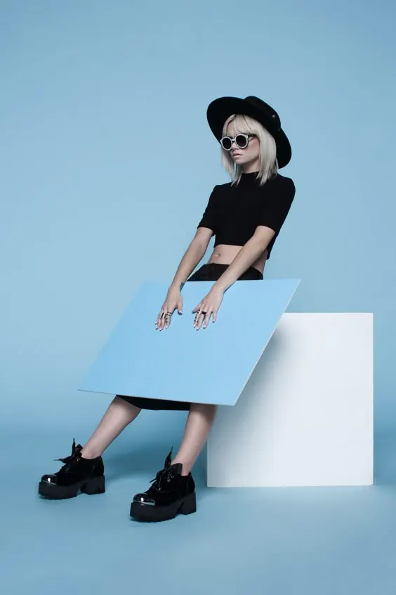 Woman with Laptop on Blue Background