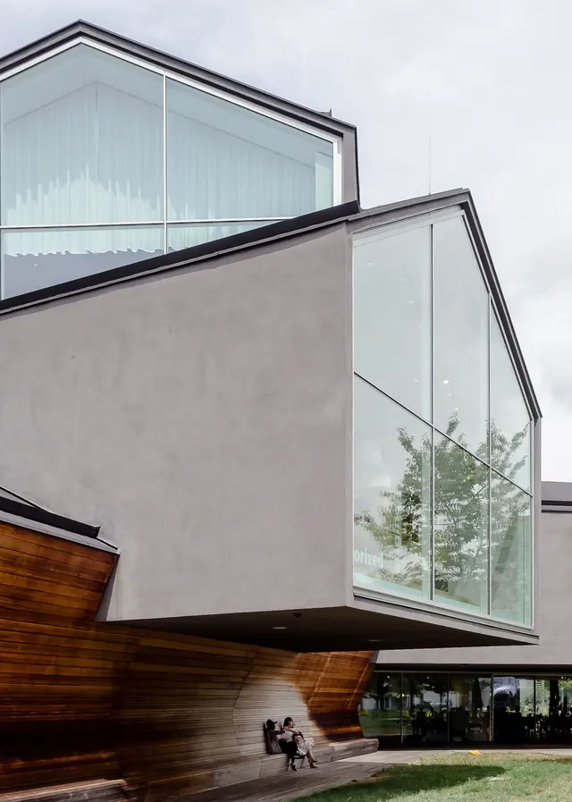 Contemporary architecture with glass and wood accents, minimal, corporate-clean, light