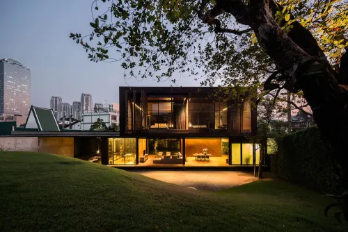 Illuminated modern cottage at dusk, photographic, minimal, warm