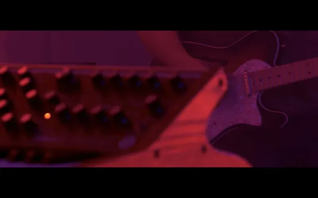 Electric guitar and keyboard in red-purple lighting, photographic, dark-mode, dark