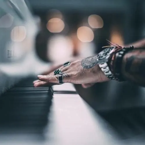 Tattooed hand with bokeh background, photographic, warm