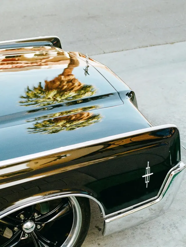 Vintage car windshield reflection landscape, photographic, minimalist, warm