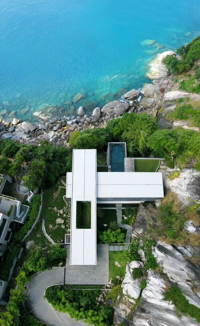 Coastal cliff residence with modernist white architecture, minimal, photographic, light