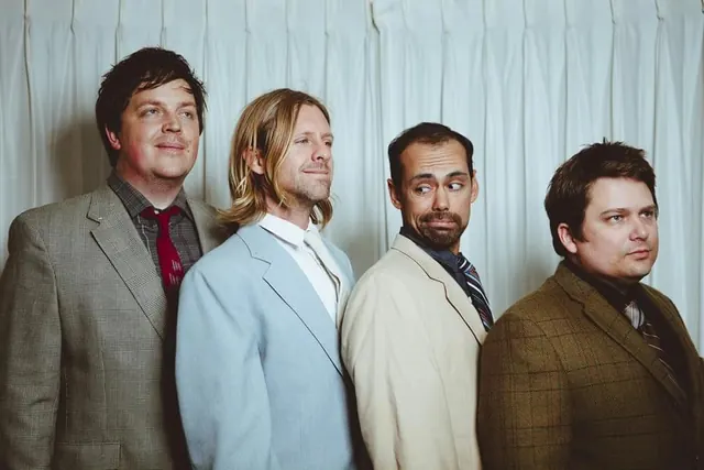 Group portrait of four men, photographic, minimal, warm