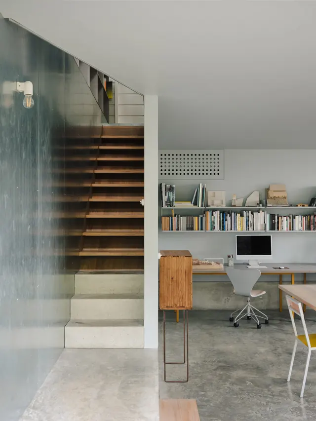 Industrial cottage studio with wooden stairs, minimal, corporate-clean, neutral