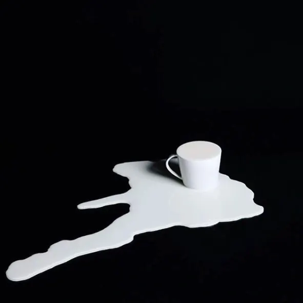 White ceramic mug on abstract shape, photographic, minimal, monochrome