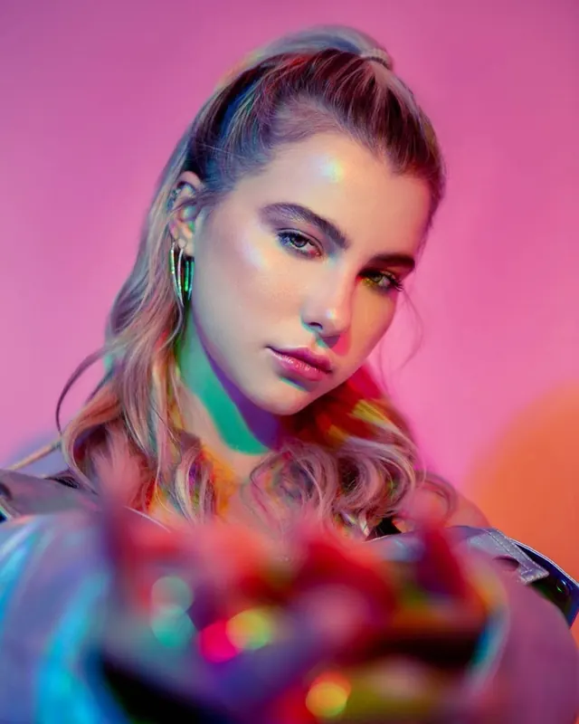Portrait with vibrant color lighting and chromatic effect, photographic, gradient-heavy, vibrant